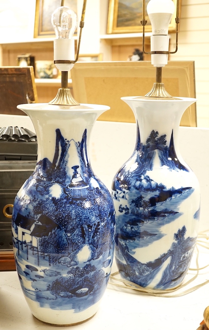 A pair of 20th century Chinese blue and white porcelain table lamps, 43 cms high excluding light fitting.